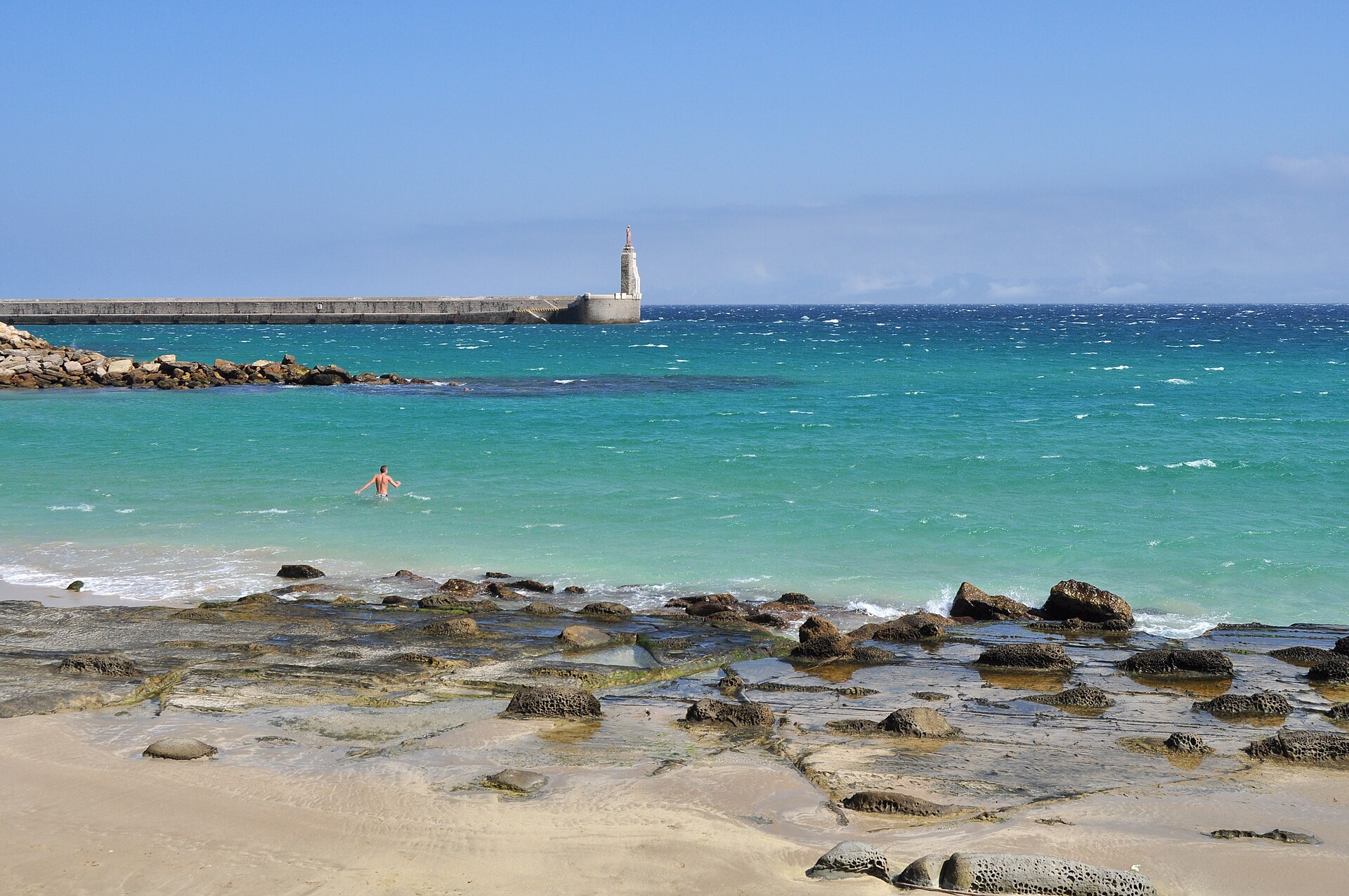 Agua turquesa junto al faro